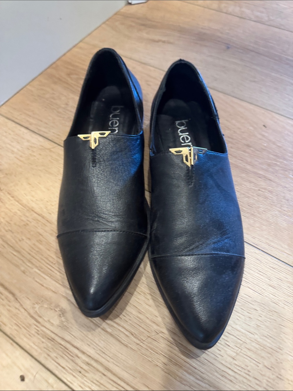Bueno Black Pointed Slip-On Loafers with Gold Emblem